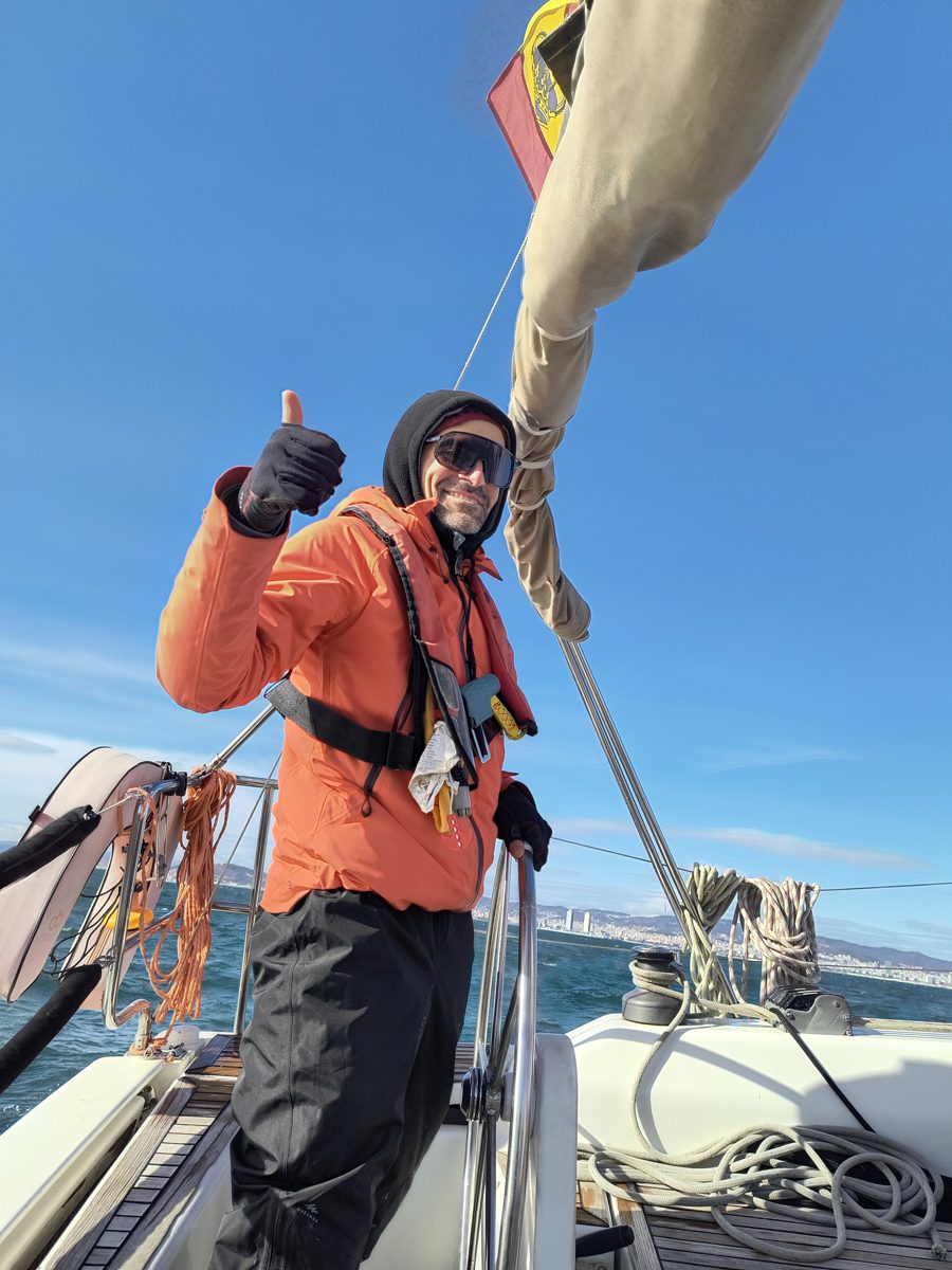 Andrew at the helm of a sailing yacht off Barcelona